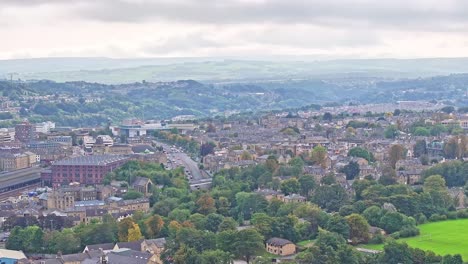 Aerial-panoramic-shot-of-Huddersfield-City-and-green-hills-during-cloudy-day-in-United-Kingdom
