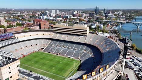 aerial-push-over-neyland-football-stadium-with-knoxville-tennessee-skyline-as-backdrop