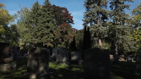 Wide-daytime-shot-with-a-tilt-down-to-empty-tombstones-and-moving-shadows