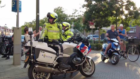 law-enforcement-police-man-on-motorcycle-standing-guard-after-football-game-in-the-Netherlands
