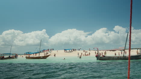 Beachgoers-and-boats-on-a-sandy-tropical-island
