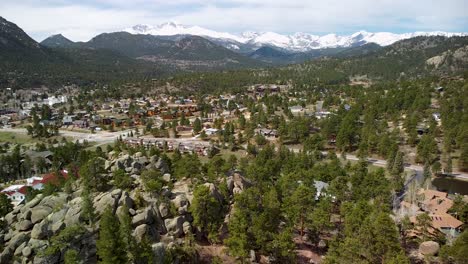 Aerial-view-of-Estes-Park,-Colorado-town-with-large-rocks-and-boulers-and-mountains-in-background