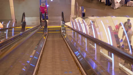 People-riding-in-a-descending-and-ascending-escalator-inside-a-mall