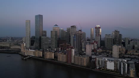 Blue-hour-aerial-view-of-Canary-Wharf-skyline-over-River-Thames,-London