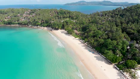 An-overhead-aerial-drone-shot-panning-from-right-to-left-of-Pansea,-a-secluded-beach-in-the-west-coast-of-Phuket,-Thailand