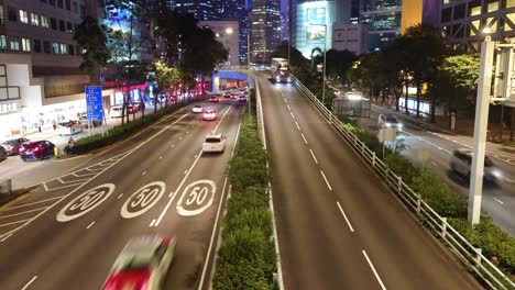 Busy-highway-during-rush-hour,-Gloucester-road-in-Wan-Chai-area-seen-from-a-footbridge-at-night,-Hongkong,-China