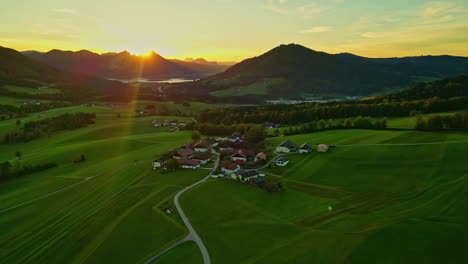 Aerial-drone-forward-shot-of-a-small-town-near-Attersee-Lake-at-sunset