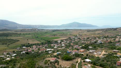 Small-village-with-farming-fields-and-sea-nearby