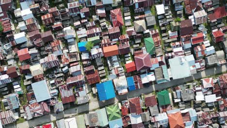 Aerial-top-down-spinning-shot-of-cemetery-area-without-space,-Philippines