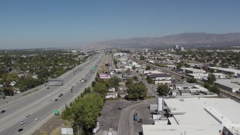 Aerial-view-of-Utah-freeway-and-residential-area-with-industrial-warehouse