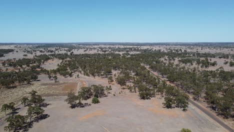 Drone-flying-over-a-desert-style-bushland-and-country-road