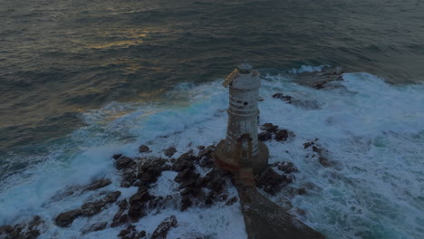 Mangiabarche-Lighthouse:-aerial-view-in-orbit-of-the-beautiful-lighthouse-and-with-the-waves-hitting