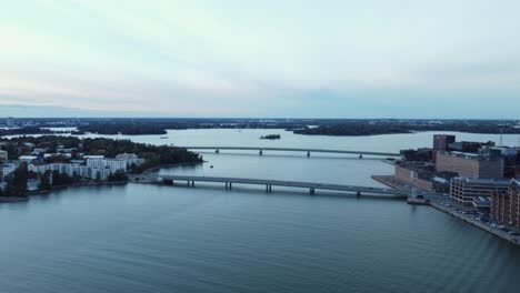 Evening-blue-hour-aerial:-Two-traffic-bridges-in-Baltic-city,-Helsinki