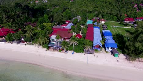 Overhead-aerial-drone-shot-panning-from-left-to-right,-showing-the-different-accommodations-that-could-be-found-in-Haad-Yao-Beach-in-Kho-Phangan-Island-in-Southern-Thailand