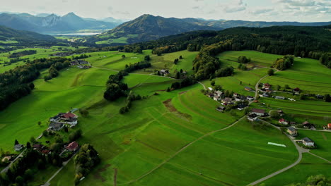 Panoramic-aerial-view-of-the-agricultural-field-and-hills-near-Attersee-Lake-in-Upper-Austria,-Salzkammergut,-Europe