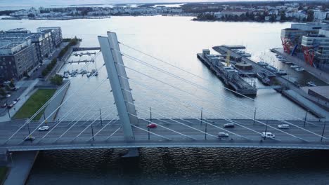 Blue-flat-light-aerial-approaches-Crusell-Bridge-traffic-in-Helsinki