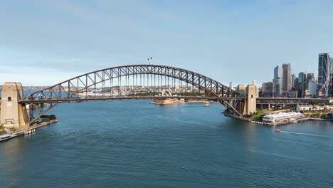 Aerial-Shot-Of-Sydney-Harbour-Bridge-Panning-to-Sydney-CBD-At-Sunset,-Australia
