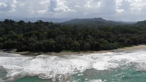 Costa-Rica-beach-drone-view-showing-sea,-shore-and-forest