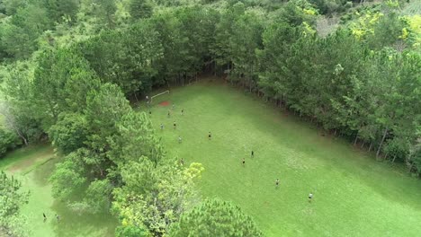 People-playing-a-soccer-match-on-a-rural-soccer-field-in-an-open-area