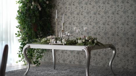 Elegant-dining-setup-with-floral-wallpaper-and-decorative-plants