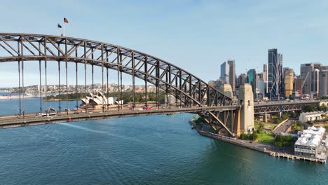 Cinematic-Aerial-Sweep-Of-Sydney-Harbour-Bridge-To-Reveal-Sydney-Opera-House-At-Sunset,-Australia