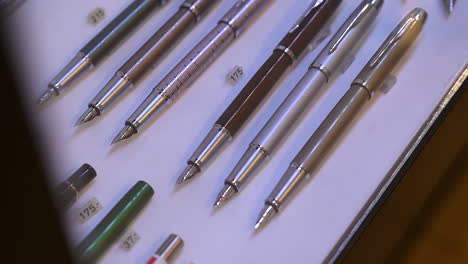 Exploring-the-Artistry-of-Fountain-Pens,-Fountain-pens-are-on-display-for-sale