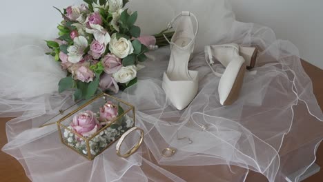 Bridal-essentials-with-bouquet,-shoes,-and-jewelry