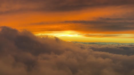 Stunning-view-of-a-colorful-red-sunset-shot-from-an-airplane-cabin-while-flying-at-sunset-at-10000m-high