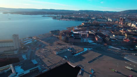 Oslo-Aerial-drone-rotating-shot-over-port-area-along-the-seaside-in-Norway-during-morning-time