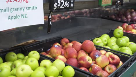 Tracking-Shot-of-Bins-of-Apples-on-Supermarket-Shelves