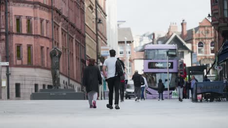 Street-level-scene-in-central-Nottingham,-England,-showcasing-pedestrians-in-slow-motion