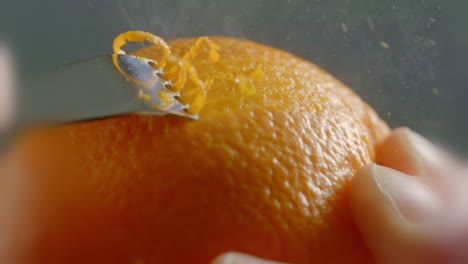 A-Tool-Crosses-Along-the-Outside-of-an-Orange-to-Peel-the-Zest