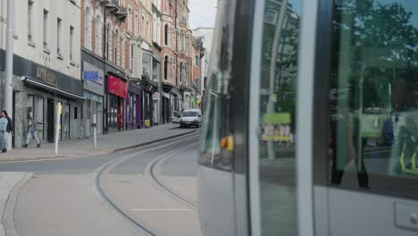 A-leisurely-scene-capturing-trams-and-pedestrians-in-slow-motion-on-the-streets-of-Nottingham,-England