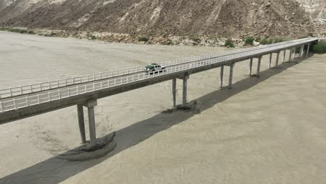 Aerial-View-Of-Truck-Driving-On-Hingol-River-Bridge