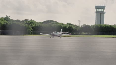 Pan-shot-of-a-parked-light-aircraft-at-an-airport's-runway