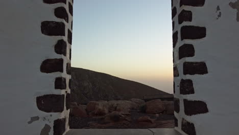 Sliding-through-the-stone-gate-of-Municipio-De-Pajara,-Fuerteventura