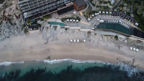 Aerial-view-from-a-luxury-hotel-overlooking-the-multi-story-building,-swimming-pools-and-vacationers-at-the-cape-thompson-hotel-in-los-cabos-on-monument-beach-during-a-mexico-vacation