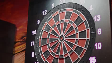 Dart-sticking-in-number-12-of-dartboard-in-slow-motion