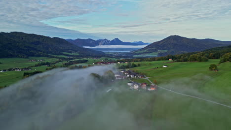 Aerial-lateral-shot-of-a-small-town-in-a-beautiful-natural-landscape