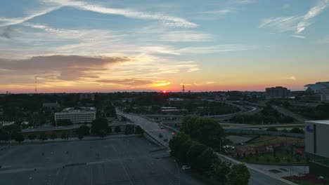Rising-drone-shot-of-road-infrastructure-during-golden-sunset-in-Atlanta-City,-Georgia---Wide-shot