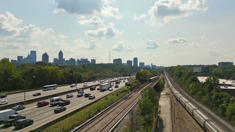 Aerial-view-of-skyline-of-Atlanta-in-Background-and-busy-highway-with-Passing-train