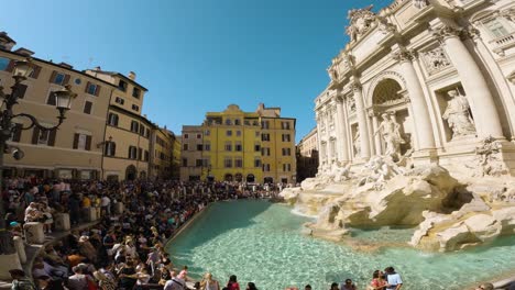 Crowds-Of-Tourists-Visit-the-Famous-Trevi-Fountain-on-a-Sunny-Day-in-Rome,-Italy