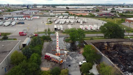 Wide-aerial-view-of-fire-truck-outside-burned-down-industrial-building