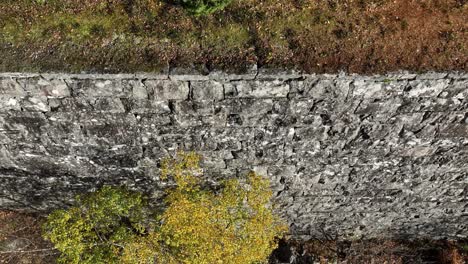Hand-built-stone-wall-along-decomissioned-railway-Bergensbanen,-Stanghelle-Norway