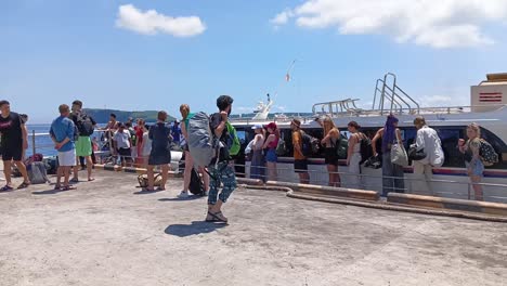 Visitors-arrive-at-the-pier-on-Nusa-Penida-Island,-Bali,-Indonesia