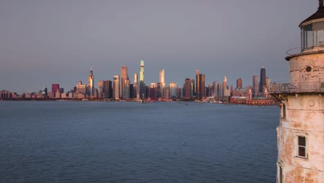 Chicago-Harbor-Lighthouse-with-city-skyline-in-background-at-sunrise-aerial-view