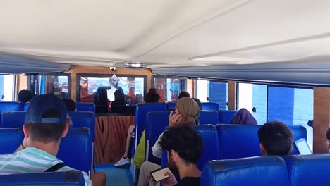 Tourists-sit-on-a-boat-speeding-towards-Nusa-Penida-Island,-Bali,-Indonesia