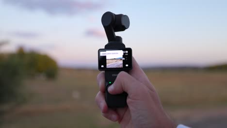 DJI-Osmo-Pocket-3-Held-In-Hand-With-Gimbal-Head-Being-Moving