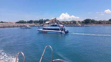 Boats-speeding-towards-Nusa-Penida-Island,-Bali,-Indonesia