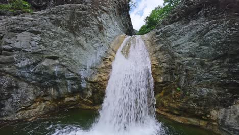 Dynamic-cinematic-fpv-flight-along-tropical-rainforest-creek-and-waterfall
